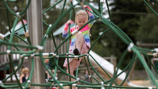 A child climbing the witches hat at Cragside.